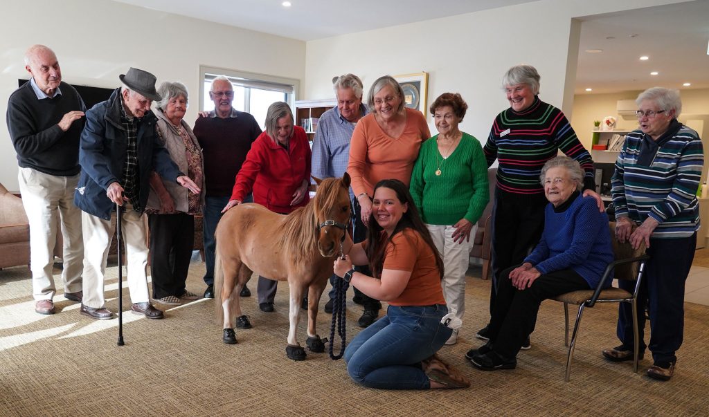 Day Clubbers pose with Maverick and his owner Ellen