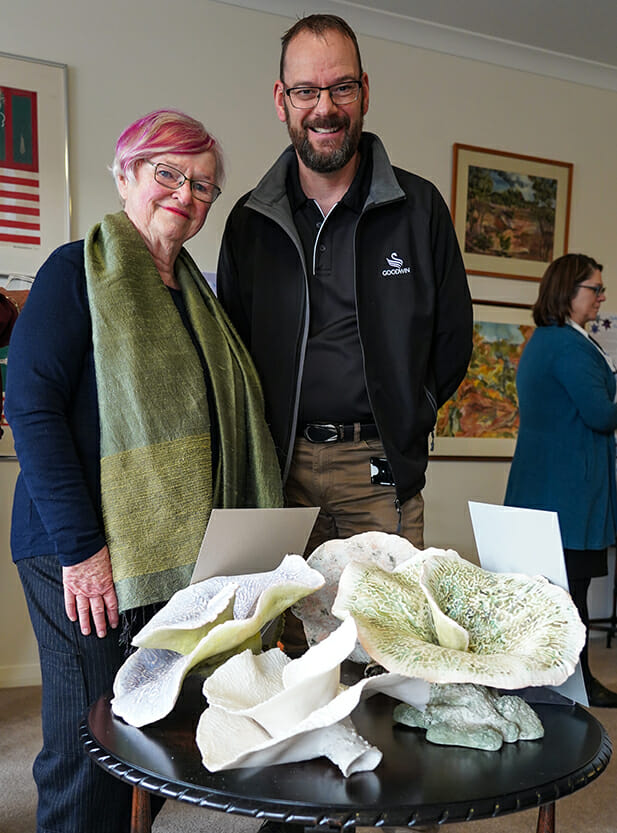 Carol and Erik standing in front of art piece