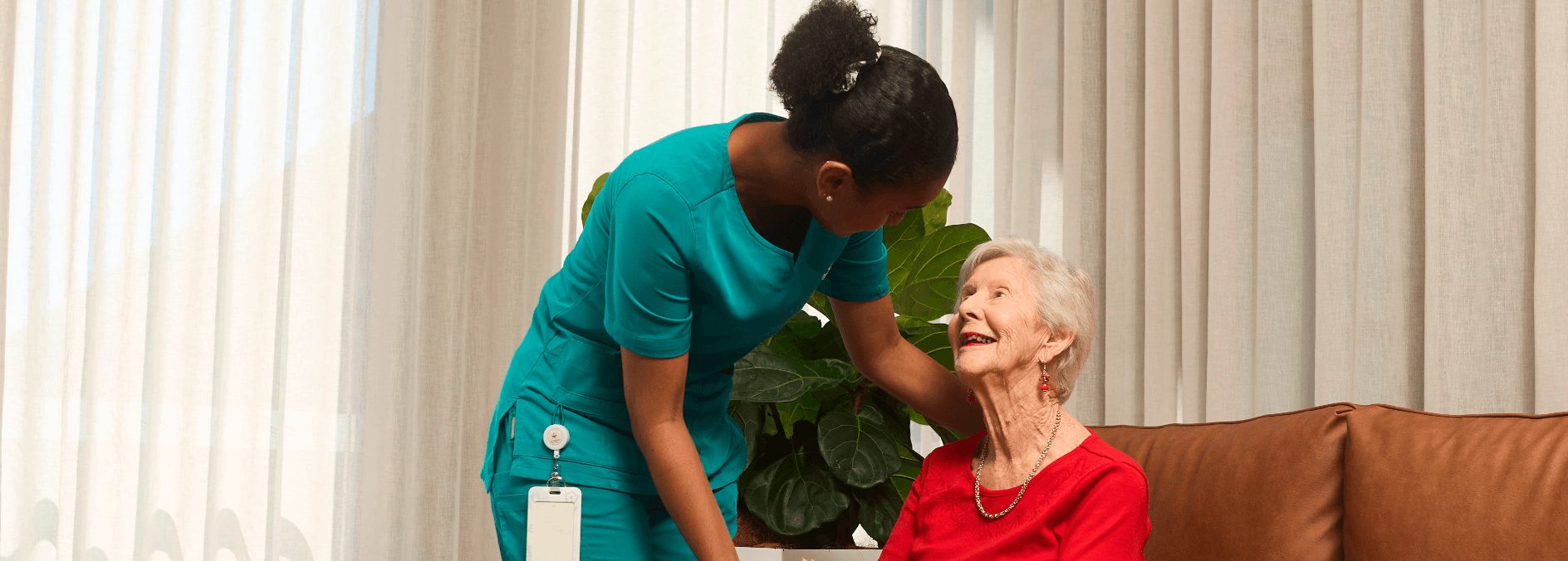 Caregiver holding hands with an elderly resident